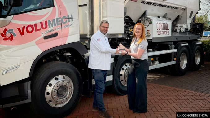 The UK Concrete Show's Charlotte Shacklock presents the New Product Award to Volumech's general manager Steve Cartwright.